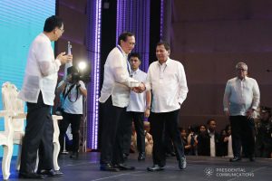 President Rodrigo Roa Duterte is welcomed on stage by Philippine Chamber of Commerce and Industry Chairman George Barcelon during the 45th Philippine Business Conference and Expo at The Manila Hotel on October 17, 2019. VALERIE ESCALERA/PRESIDENTIAL PHOTO