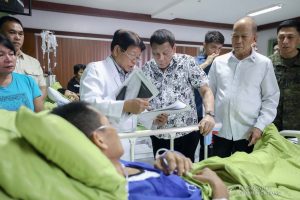 President Rodrigo Roa Duterte examines the injury of one of the wounded law enforcers he visited at the Divine Word Hospital in Tacloban City on November 15, 2019. ACE MORANDANTE/PRESIDENTIAL PHOTO