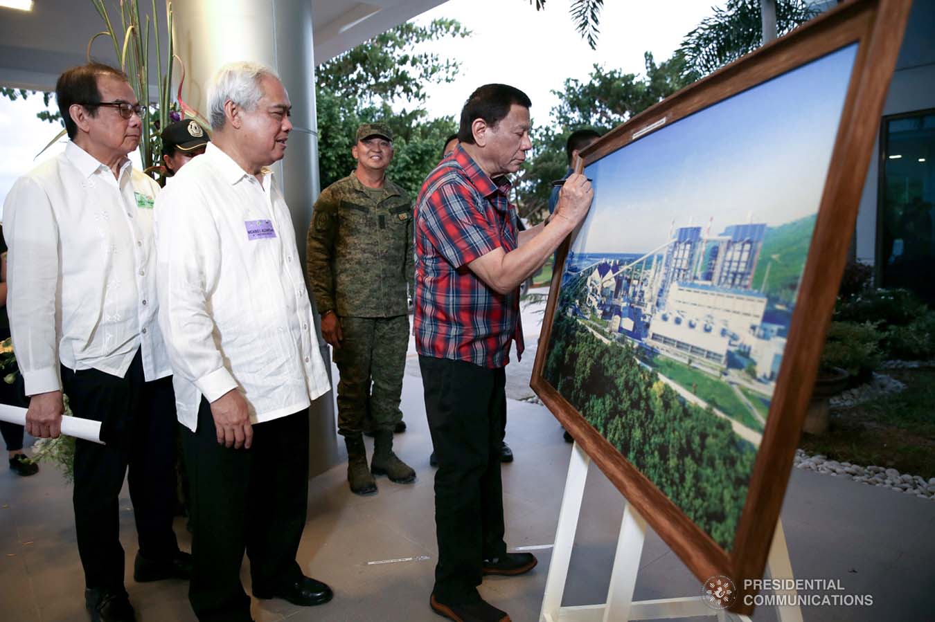 President Rodrigo Roa Duterte signs the framed photograph of the Sarangani Energy Corporation (SEC) I and II Plant Site during its inauguration in Maasim, Sarangani Province on November 22, 2019. SIMEON CELI JR./PRESIDENTIAL PHOTO
