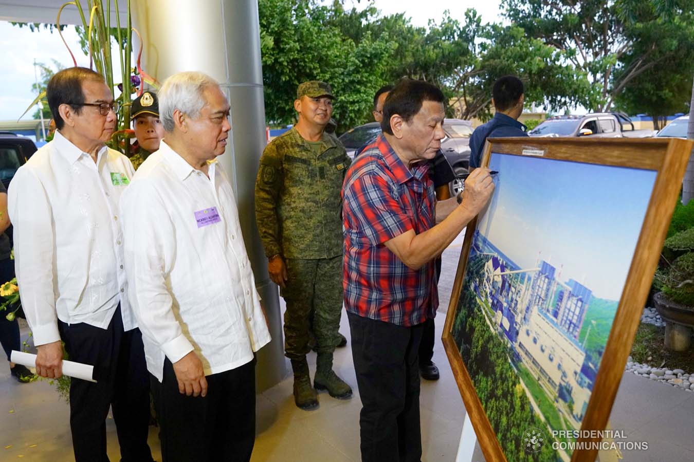 President Rodrigo Roa Duterte signs the framed photograph of the Sarangani Energy Corporation (SEC) I and II Plant Site during its inauguration in Maasim, Sarangani Province on November 22, 2019. JOEY DALUMPINES/PRESIDENTIAL PHOTO