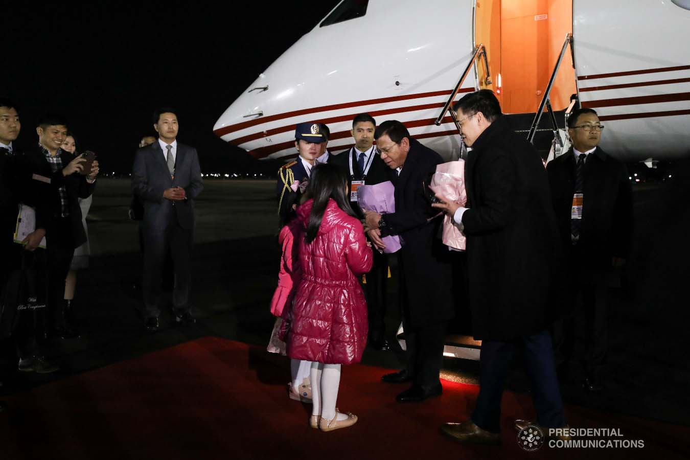 President Rodrigo Roa Duterte receives a token from the children who are part of the reception party upon his arrival at the Gimhae Air Base in Busan, Republic of Korea on November 25, 2019. KARL NORMAN ALONZO/PRESIDENTIAL PHOTO