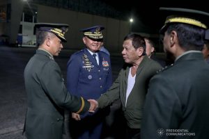 President Rodrigo Roa Duterte is welcomed by a military officer upon his arrival at the Villamor Air Base in Pasay City on November 26, 2019 after his successful participation in the Association of Southeast Asian Nations (ASEAN)-Republic of Korea Commemorative Summit in Busan. ALFRED FRIAS/PRESIDENTIAL PHOTO