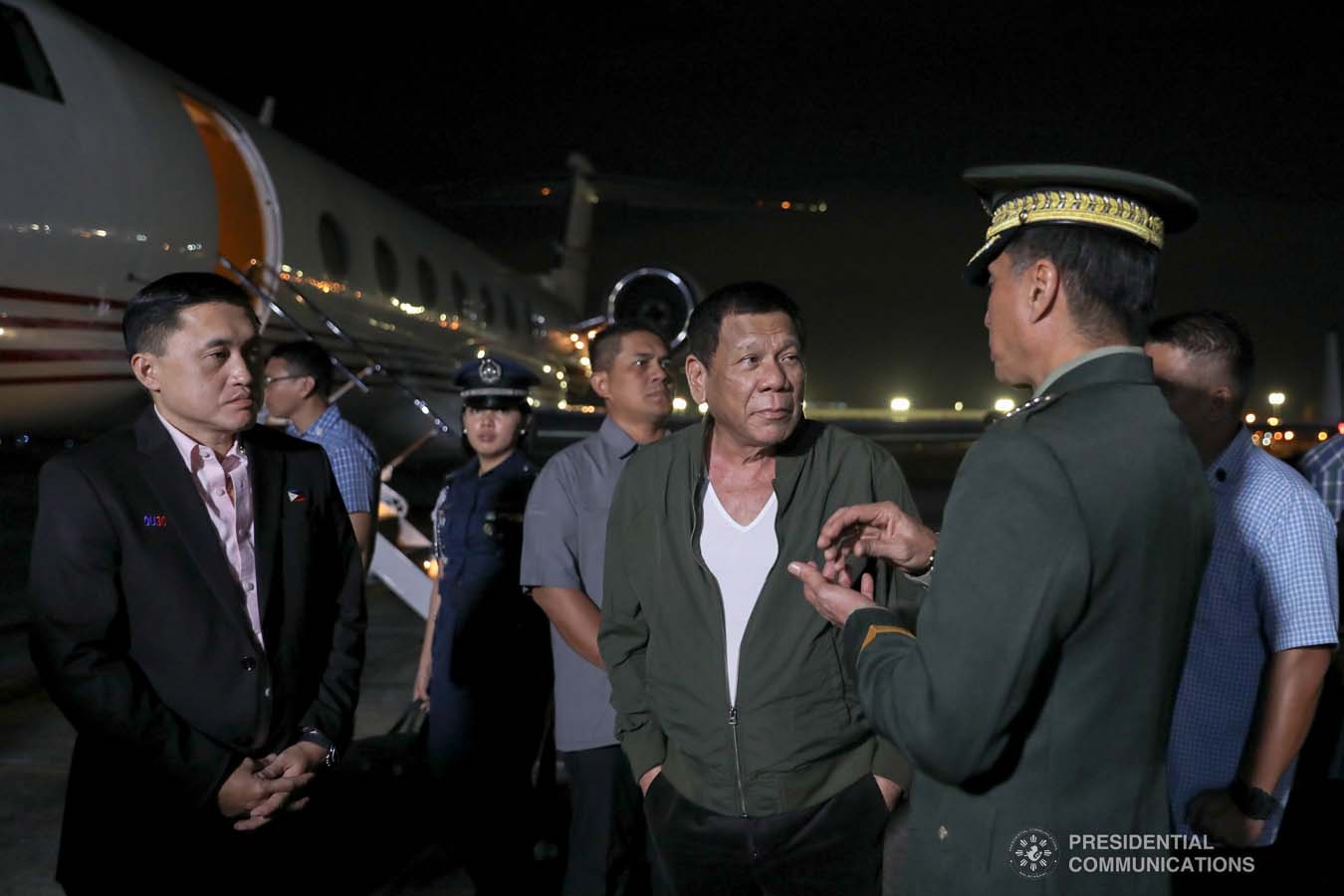 President Rodrigo Roa Duterte chats with military officers upon his arrival at the Villamor Air Base in Pasay City on November 26, 2019 after his successful participation in the Association of Southeast Asian Nations (ASEAN)-Republic of Korea Commemorative Summit in Busan. ALFRED FRIAS/PRESIDENTIAL PHOTO