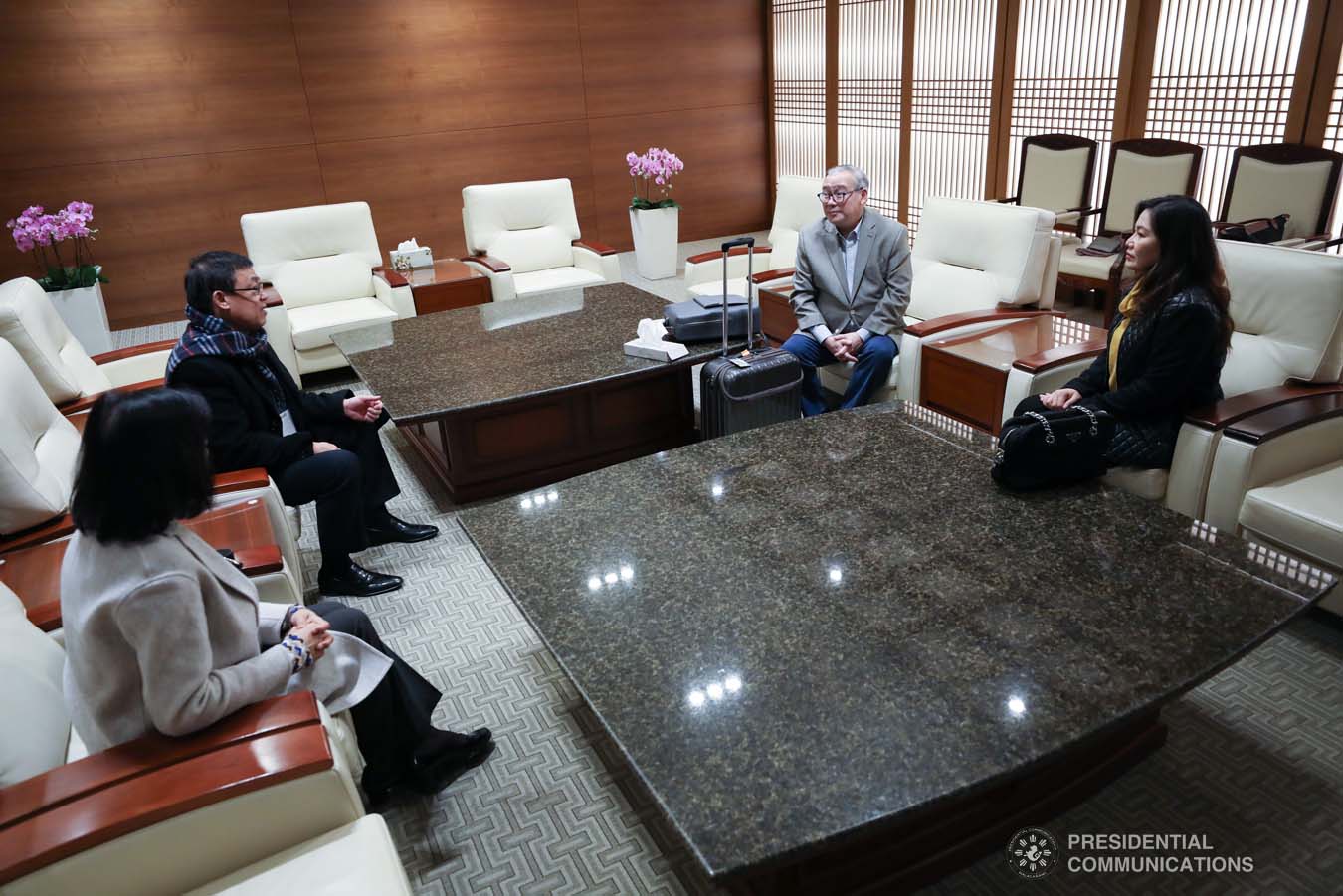 President Rodrigo Roa Duterte's partner Cielito Avanceña chats with Foreign Affairs Secretary Teodoro Locsin Jr. as she prepares to leave for Manila after joining the President in various events during the Association of Southeast Asian Nations (ASEAN)-Republic of Korea Commemorative Summit in Busan on November 26, 2019. RICHARD MADELO/PRESIDENTIAL PHOTO