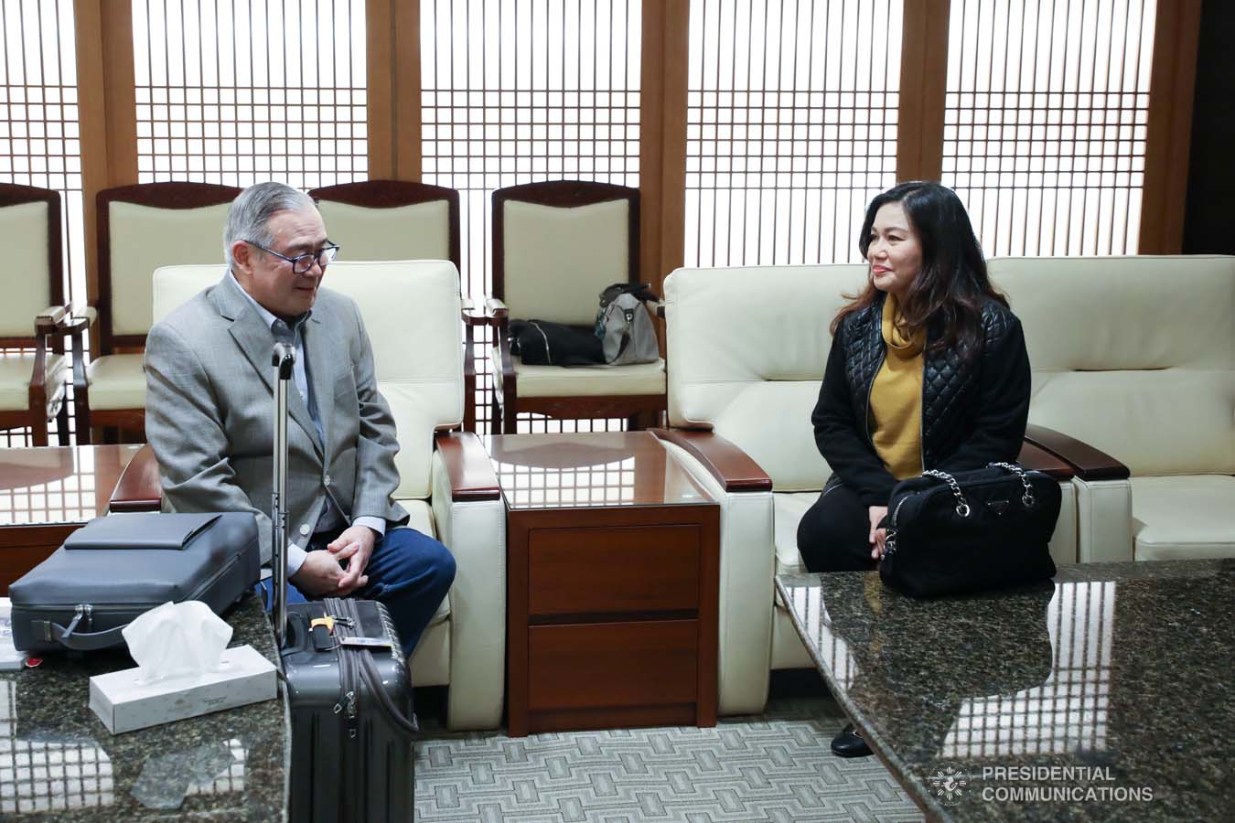 President Rodrigo Roa Duterte's partner Cielito Avanceña chats with Foreign Affairs Secretary Teodoro Locsin Jr. as she prepares to leave for Manila after joining the President in various events during the Association of Southeast Asian Nations (ASEAN)-Republic of Korea Commemorative Summit in Busan on November 26, 2019. RICHARD MADELO/PRESIDENTIAL PHOTO