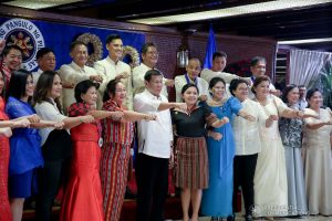 President Rodrigo Roa Duterte strikes his signature pose with the officials of the Overseas Workers Welfare Administration during the awarding ceremony for the 2019 Model Overseas Filipino Worker (OFW) Family of the Year Award (MOFYA) at the Malacañan Palace on November 28, 2019. ALBERT ALCAIN/PRESIDENTIAL PHOTO