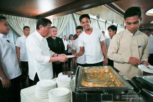 President Rodrigo Roa Duterte serves the kitchen staff after leading the awarding ceremony for the 2019 Model Overseas Filipino Worker (OFW) Family of the Year Award (MOFYA) at the Malacañan Palace on November 28, 2019. ALBERT ALCAIN/PRESIDENTIAL PHOTO