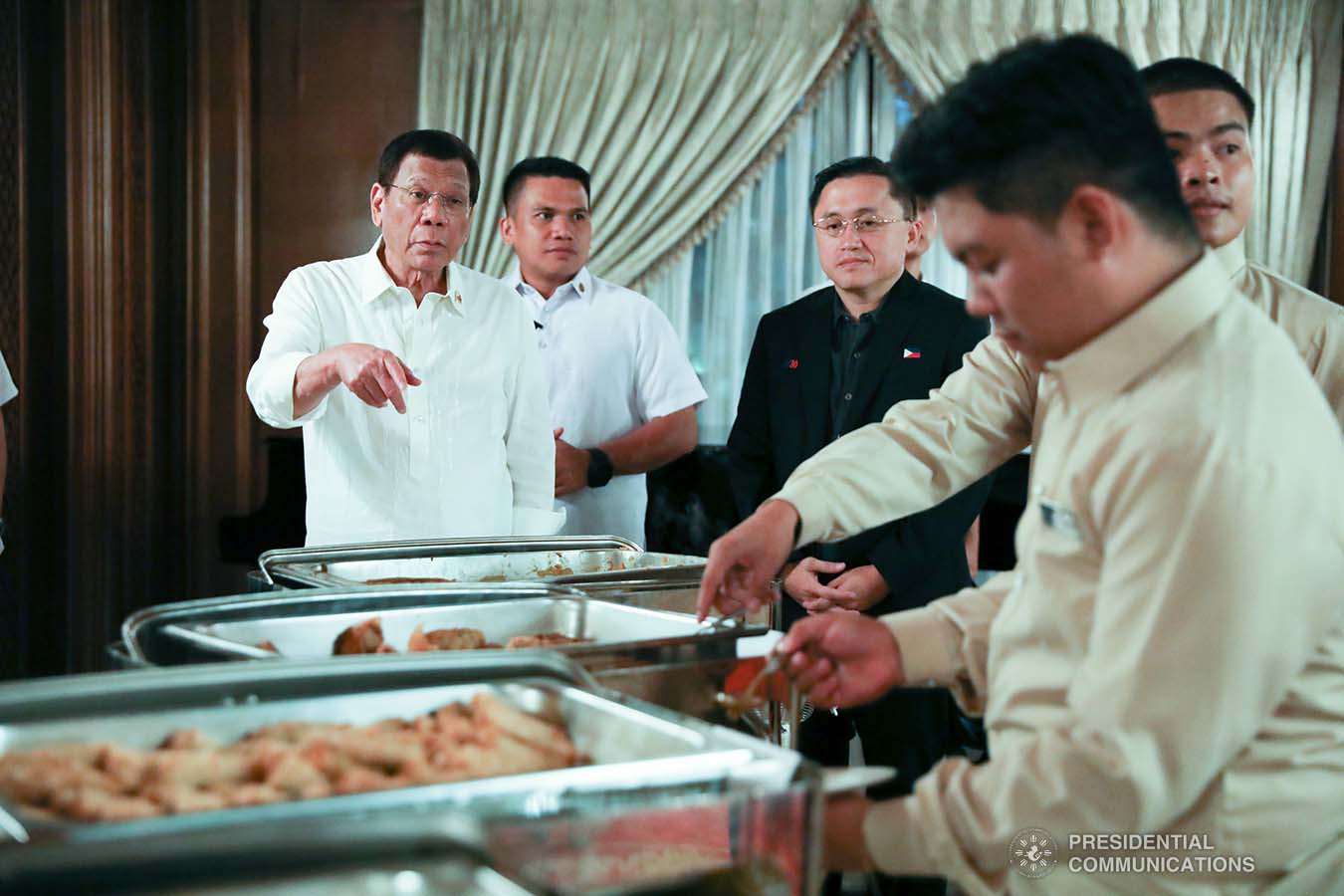 President Rodrigo Roa Duterte serves the kitchen staff after leading the awarding ceremony for the 2019 Model Overseas Filipino Worker (OFW) Family of the Year Award (MOFYA) at the Malacañan Palace on November 28, 2019. TOTO LOZANO/PRESIDENTIAL PHOTO