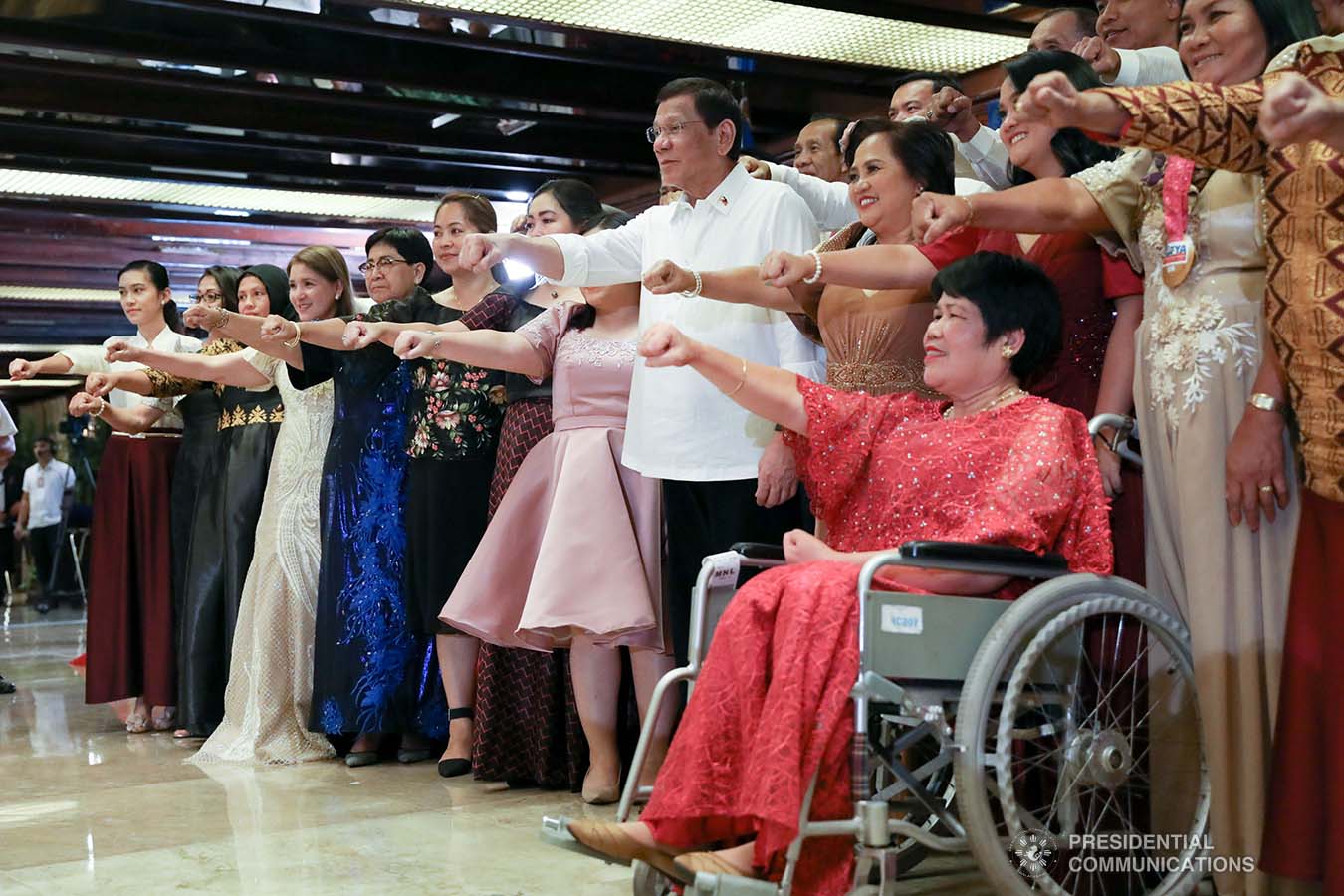 President Rodrigo Roa Duterte strikes his signature pose with the officials of the Overseas Workers Welfare Administration during the awarding ceremony for the 2019 Model Overseas Filipino Worker (OFW) Family of the Year Award (MOFYA) at the Malacañan Palace on November 28, 2019. TOTO LOZANO/PRESIDENTIAL PHOTO