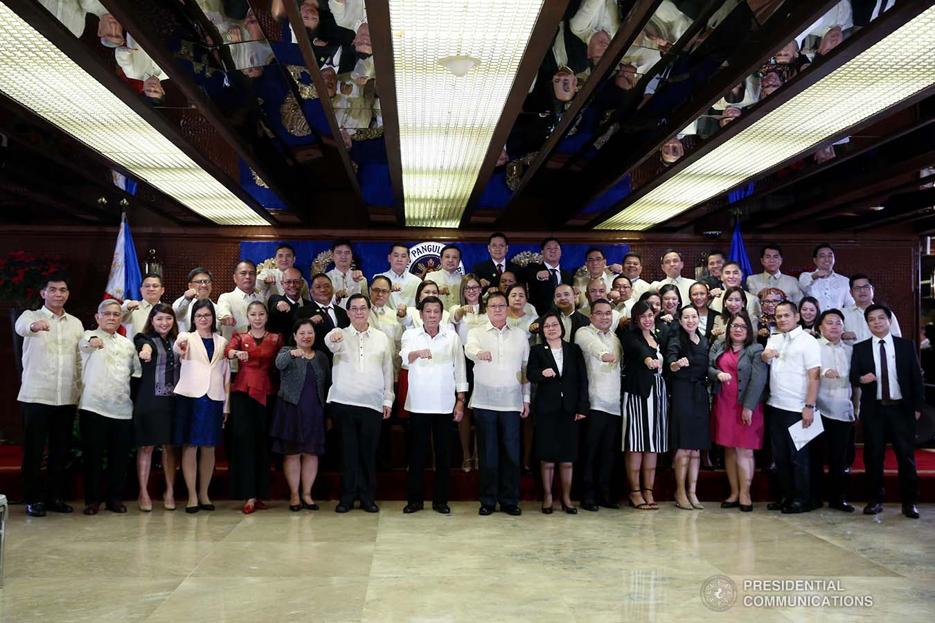 President Rodrigo Roa Duterte strikes his signature pose with the newly-appointed government officials during their oath-taking ceremony at the Malacañan Palace on December 3, 2019. ALBERT ALCAIN/PRESIDENTIAL PHOTO