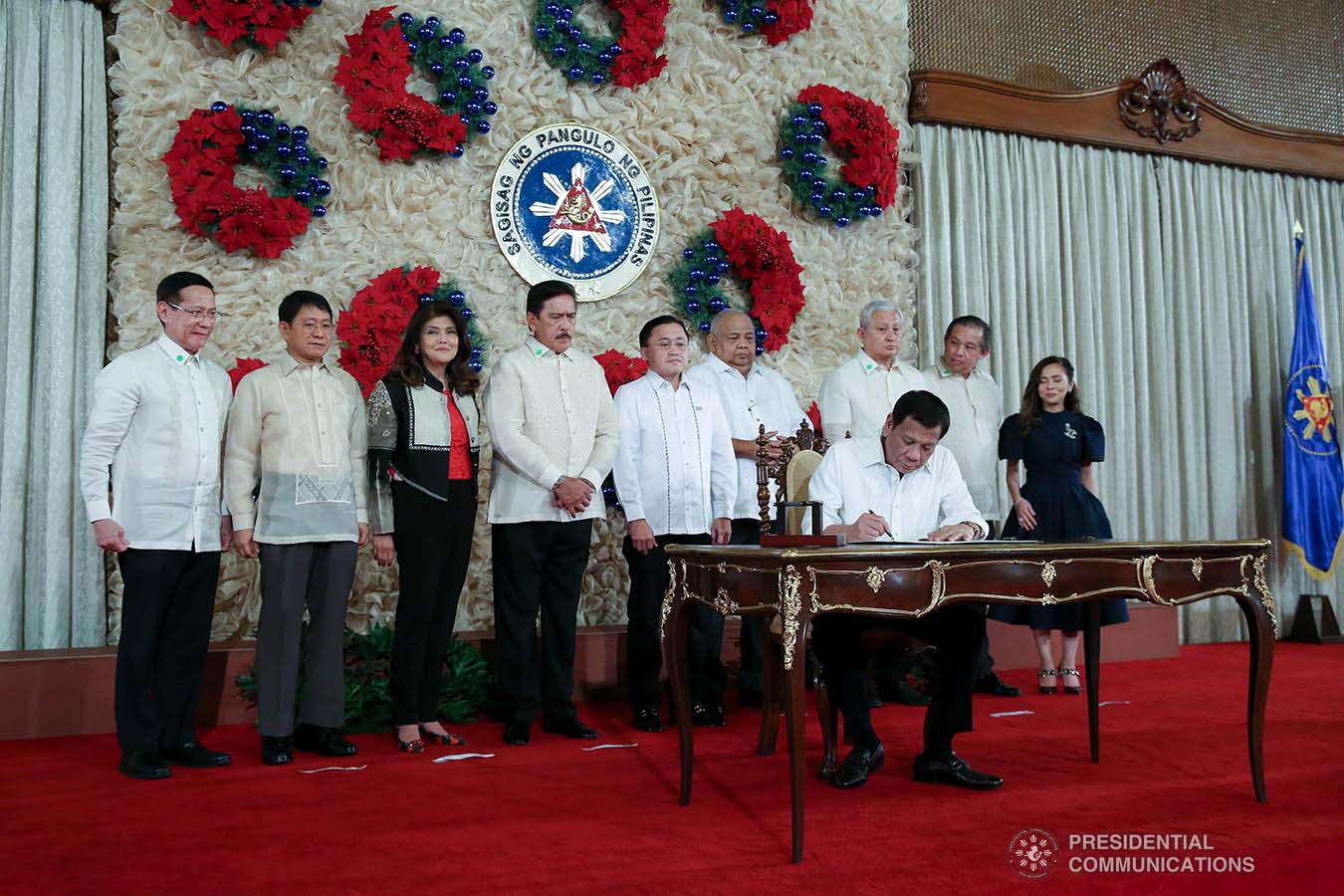 President Rodrigo Roa Duterte signs the Postponement of the 2020 Barangay and Sangguniang Kabataan Elections Act and the Malasakit Center Act during a ceremony at the Malacañan Palace on December 3, 2019. ALBERT ALCAIN/PRESIDENTIAL PHOTO