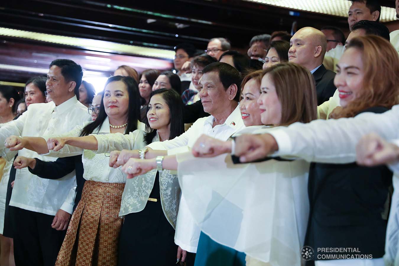 President Rodrigo Roa Duterte strikes his signature pose with the newly-appointed government officials during their oath-taking ceremony at the Malacañan Palace on December 3, 2019. TOTO LOZANO/PRESIDENTIAL PHOTO
