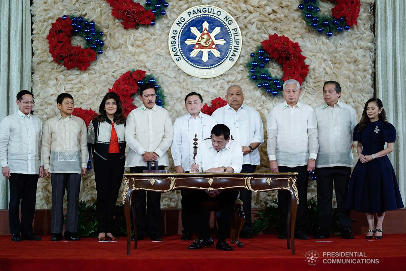 President Rodrigo Roa Duterte signs the Postponement of the 2020 Barangay and Sangguniang Kabataan Elections Act and the Malasakit Center Act during a ceremony at the Malacañan Palace on December 3, 2019. KING RODRIGUEZ/PRESIDENTIAL PHOTO