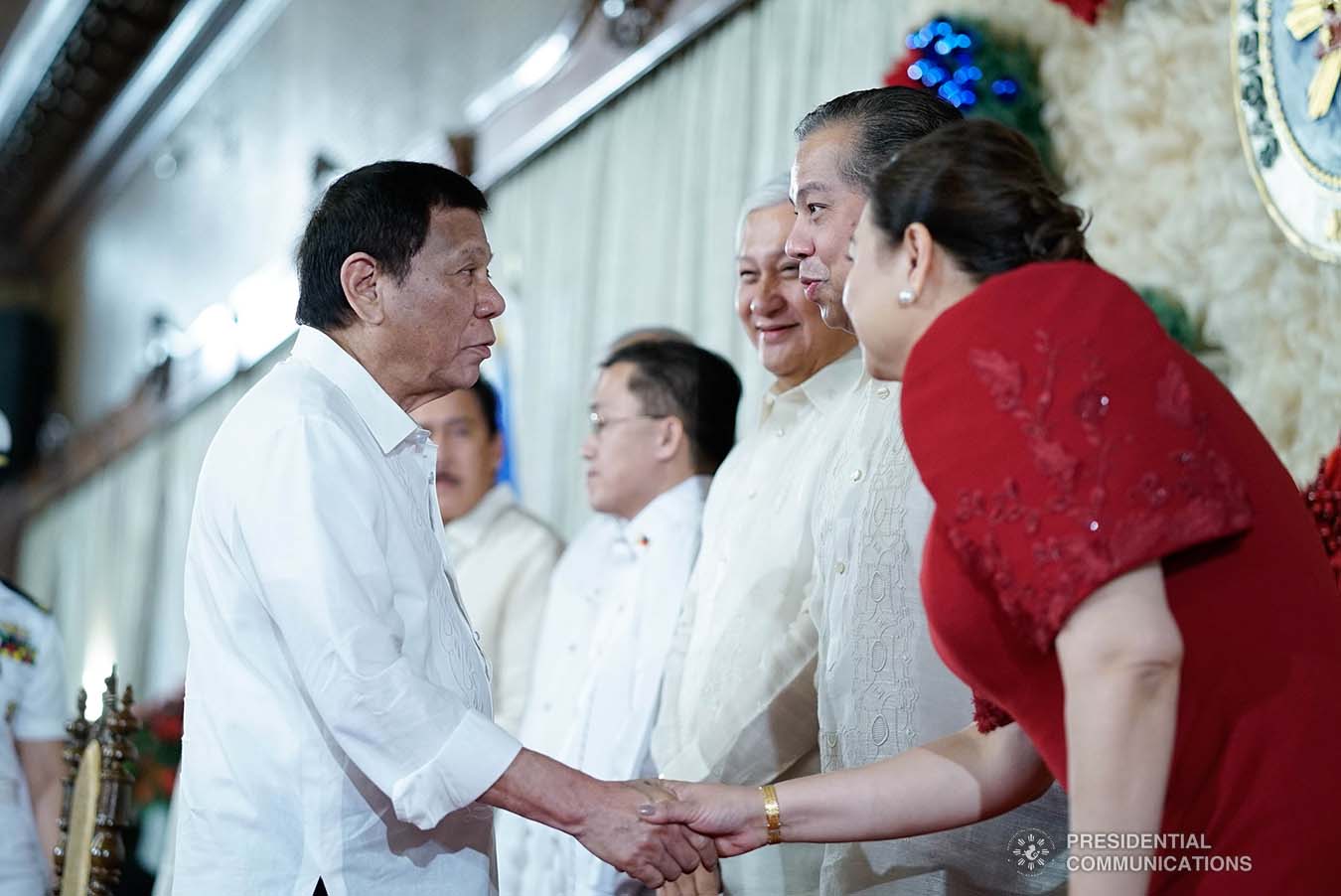 President Rodrigo Roa Duterte greets House Majority Leader Martin Romualdez and Negros Occidental Fourth District Representative Juliet Ferrer during the ceremonial signing of the Postponement of the 2020 Barangay and Sangguniang Kabataan Elections Act and the Malasakit Center Act at the Malacañan Palace on December 3, 2019. KING RODRIGUEZ/PRESIDENTIAL PHOTO