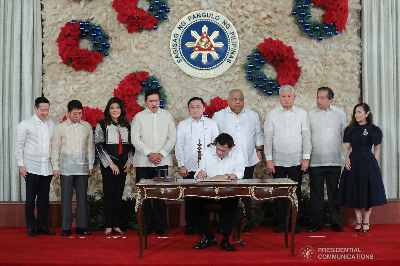 President Rodrigo Roa Duterte signs the Postponement of the 2020 Barangay and Sangguniang Kabataan Elections Act and the Malasakit Center Act during a ceremony at the Malacañan Palace on December 3, 2019. VALERIE ESCALERA/PRESIDENTIAL PHOTO
