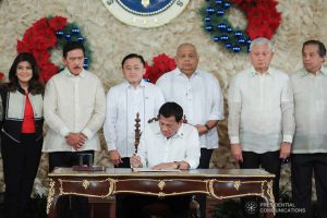 President Rodrigo Roa Duterte signs the Postponement of the 2020 Barangay and Sangguniang Kabataan Elections Act and the Malasakit Center Act during a ceremony at the Malacañan Palace on December 3, 2019. VALERIE ESCALERA/PRESIDENTIAL PHOTO