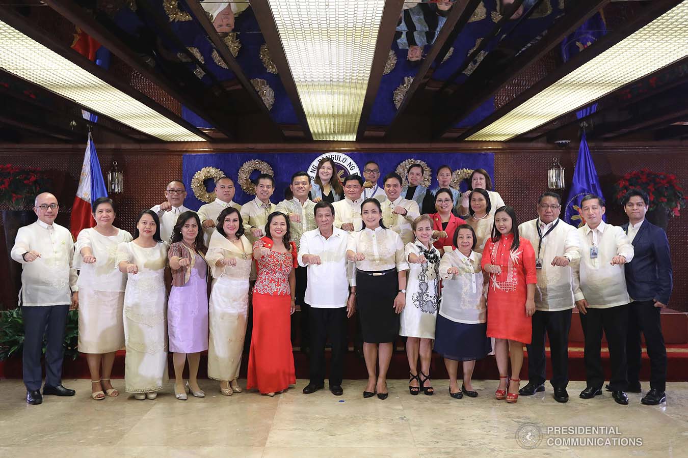 President Rodrigo Roa Duterte strikes his signature pose with the newly-appointed government officials during their oath-taking ceremony at the Malacañan Palace on December 3, 2019. VALERIE ESCALERA/PRESIDENTIAL PHOTO