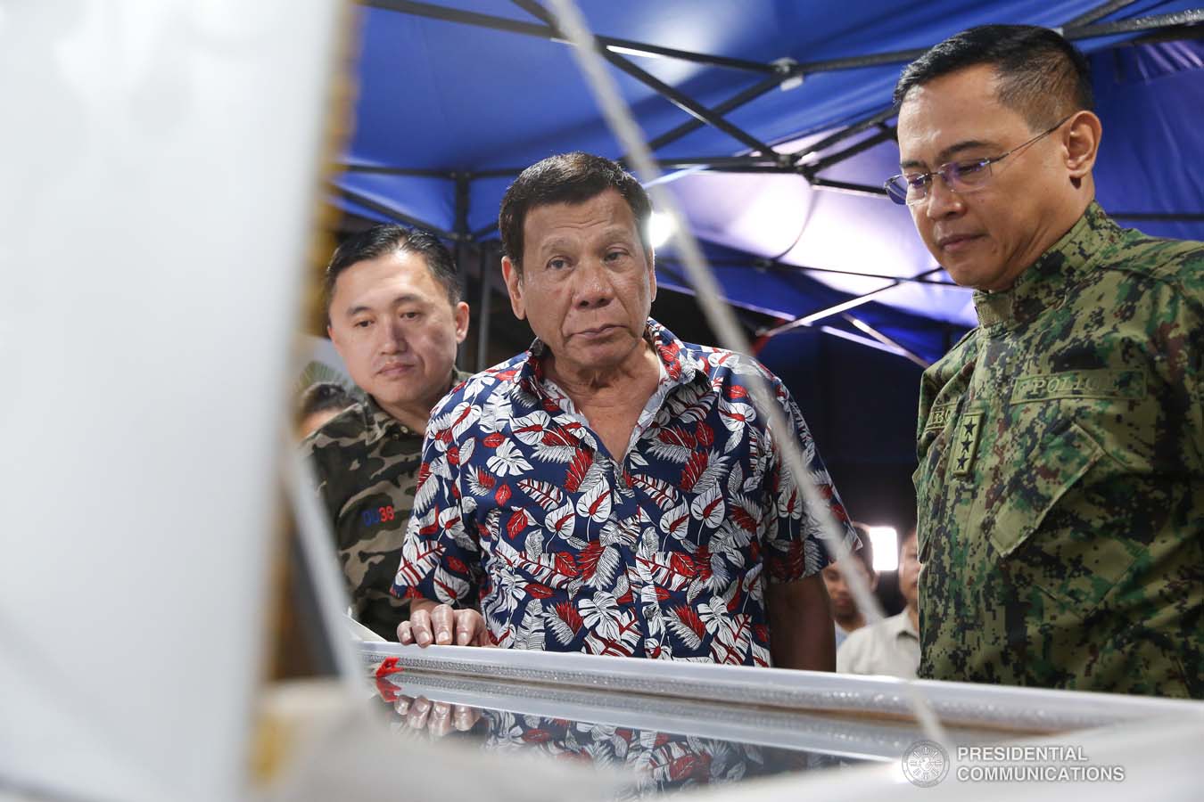 President Rodrigo Roa Duterte pays his last respects to the late Police Senior Master Sergeant Jason Magno as he visits the wake in Initao, Misamis Oriental on December 5, 2019. ALBERT ALCAIN/PRESIDENTIAL PHOTO