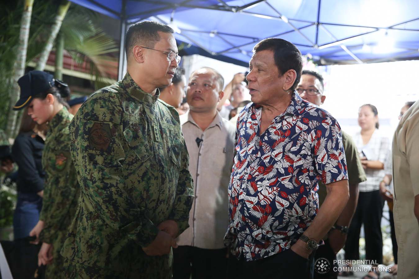 President Rodrigo Roa Duterte discusses matters with Philippine National Police Officer-in-Charge Lieutenant General Archie Gamboa while visiting the wake of the late Police Senior Master Sergeant Jason Magno in Initao, Misamis Oriental on December 5, 2019. ALBERT ALCAIN/PRESIDENTIAL PHOTO