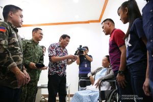 President Rodrigo Roa Duterte confers the Order of Lapu-Lapu Rank of Kampilan on a wounded police officer he visited at Misamis Oriental Provincial Hospital (MOPH) in Initao town on December 5, 2019. ALBERT ALCAIN/PRESIDENTIAL PHOTO