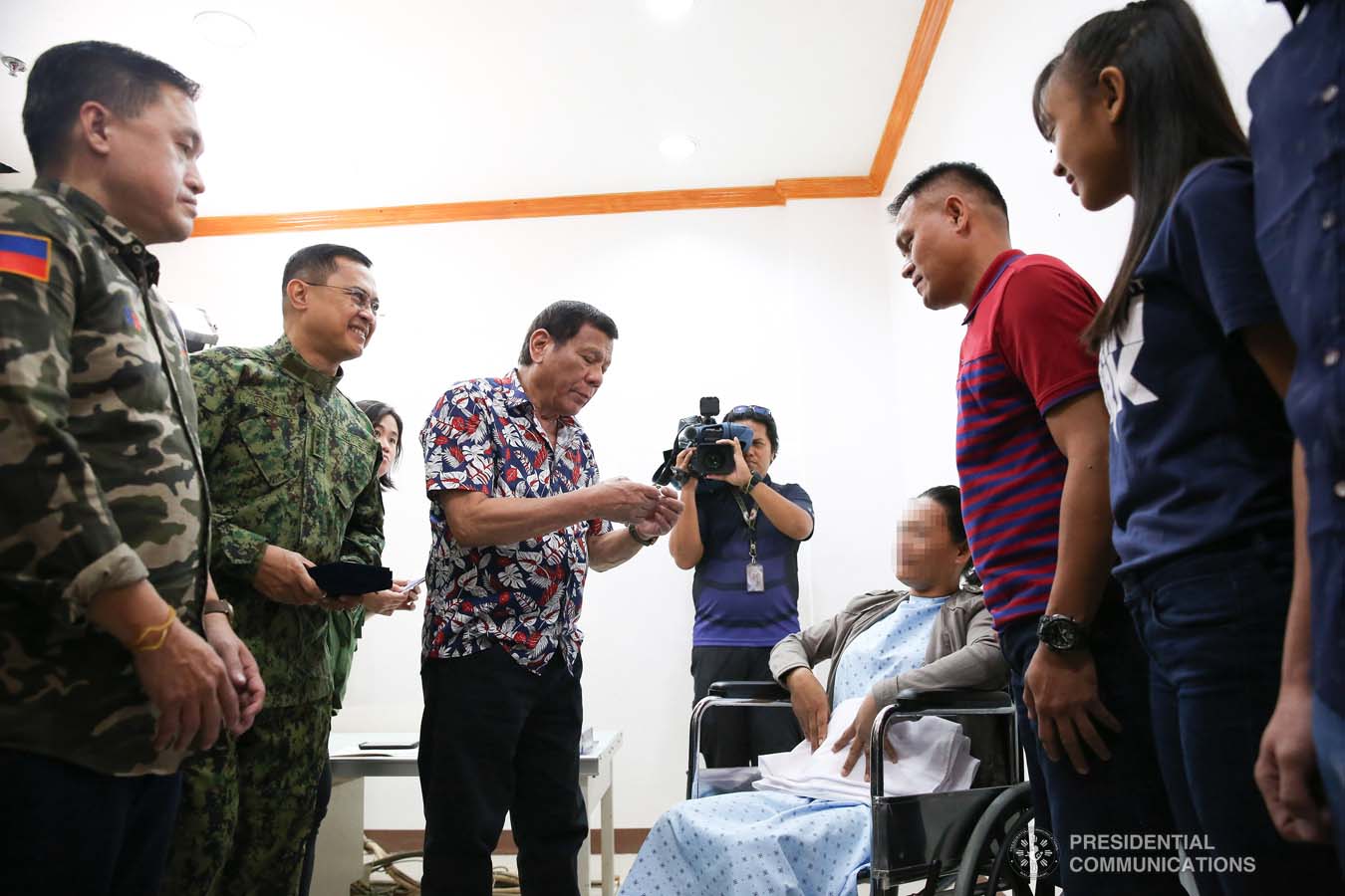 President Rodrigo Roa Duterte confers the Order of Lapu-Lapu Rank of Kampilan on a wounded police officer he visited at Misamis Oriental Provincial Hospital (MOPH) in Initao town on December 5, 2019. ALBERT ALCAIN/PRESIDENTIAL PHOTO