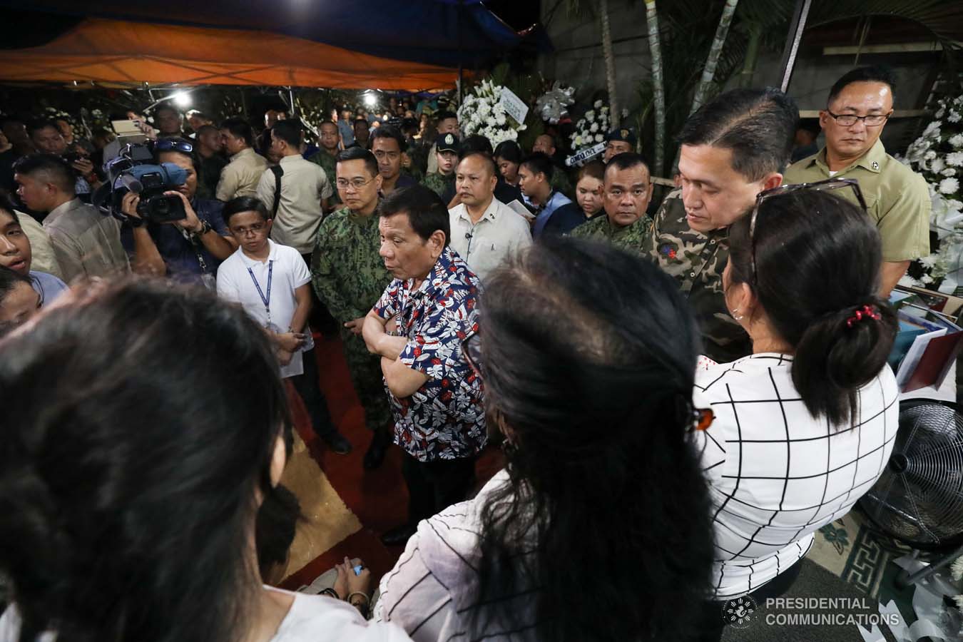 President Rodrigo Roa Duterte condoles with the family of the late Police Senior Master Sergeant Jason Magno as he visits the wake in Initao, Misamis Oriental on December 5, 2019. TOTO LOZANO/PRESIDENTIAL PHOTO