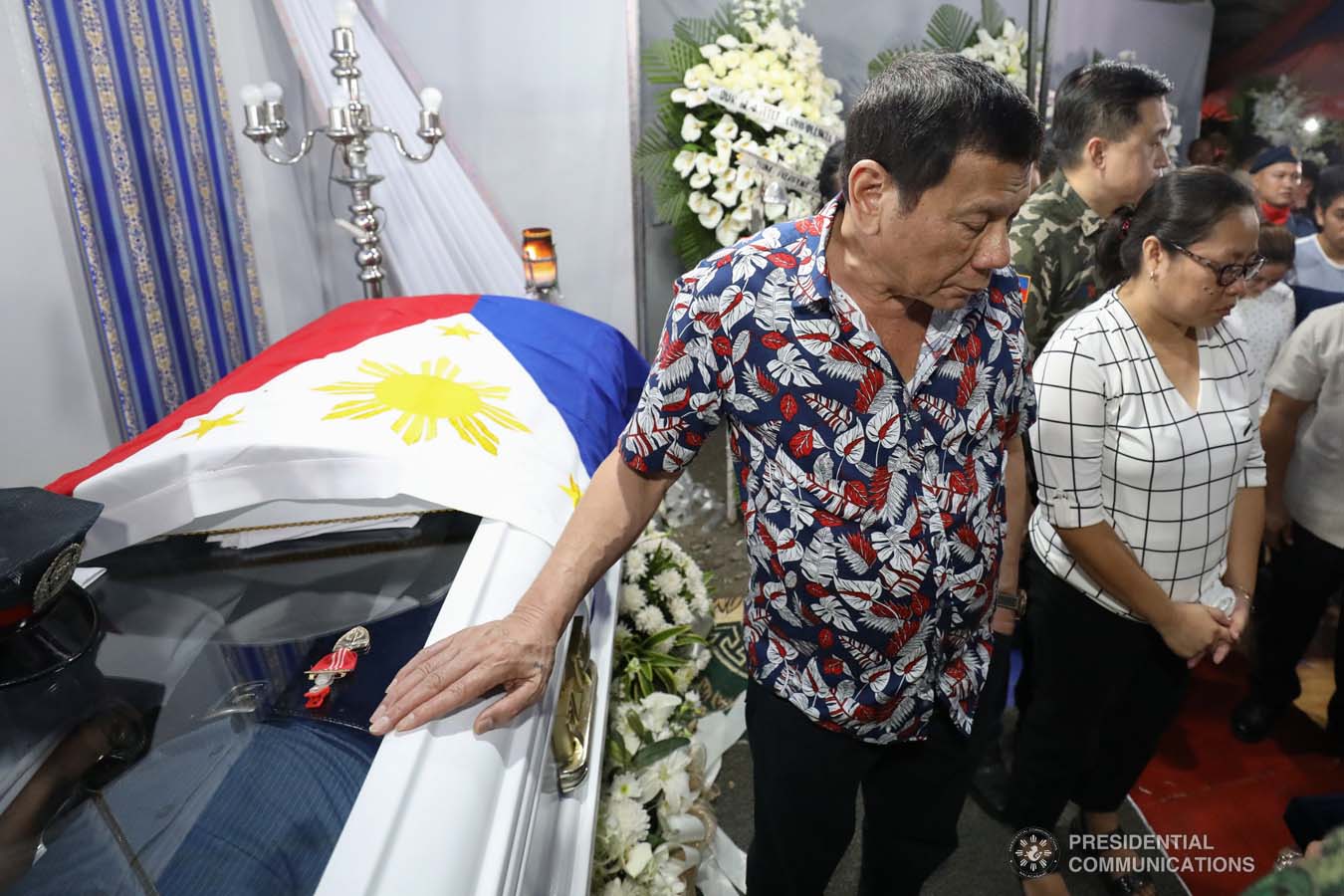 President Rodrigo Roa Duterte posthumously awards the Order of Lapu-Lapu Rank of Kalasag to the late Police Senior Master Sergeant Jason Magno as he visits the wake in Initao, Misamis Oriental on December 5, 2019. TOTO LOZANO/PRESIDENTIAL PHOTO