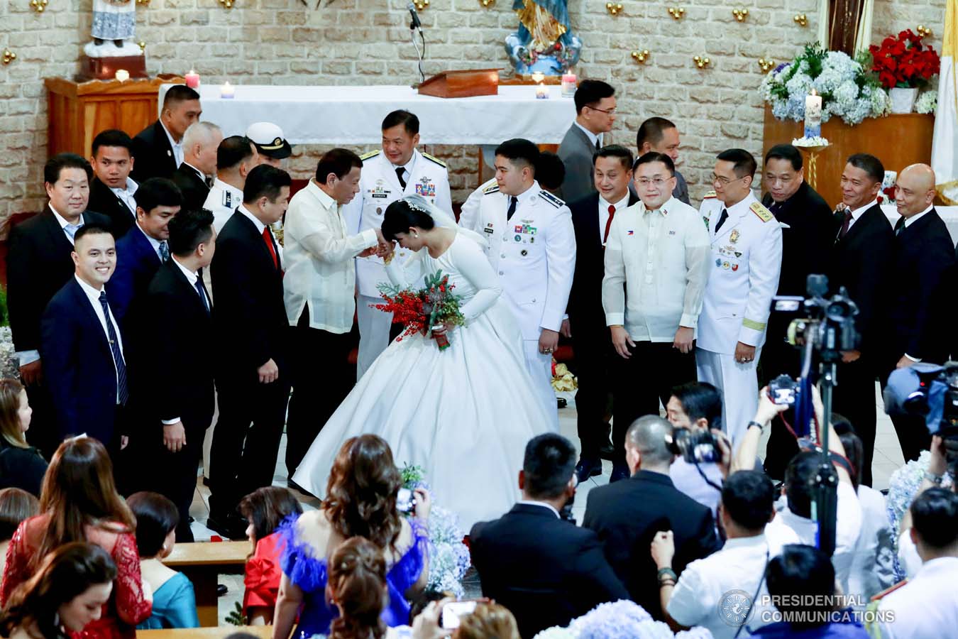 President Rodrigo Roa Duterte greets newlyweds Makkaria and First Lieutenant James Estoesta during the wedding at the St. Ignatius Chapel in Fort Gen. Gregorio H. del Pilar, Baguio City on December 8, 2019. RICHARD MADELO/PRESIDENTIAL PHOTO