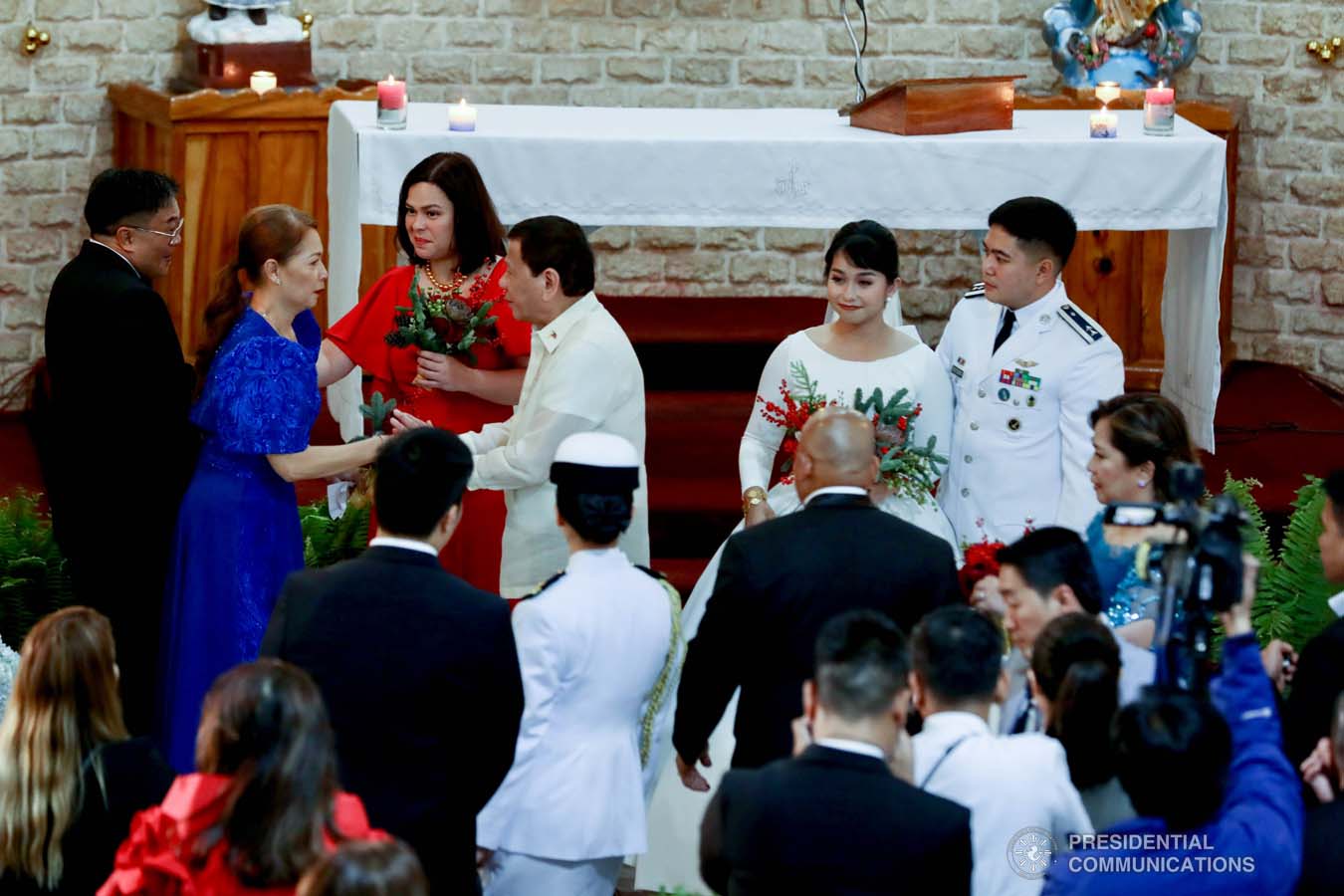 President Rodrigo Roa Duterte and his daughter Davao City Mayor Sara Duterte-Carpio greet the parents of the groom during the wedding of Makkaria and First Lieutenant James Estoesta at the St. Ignatius Chapel in Fort Gen. Gregorio H. del Pilar, Baguio City on December 8, 2019. RICHARD MADELO/PRESIDENTIAL PHOTO