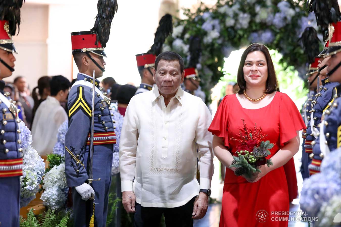 President Rodrigo Roa Duterte walks down the aisle with daughter Davao City Mayor Sara Duterte-Carpio as he attends as one of the principal sponsors during the wedding of Makkaria and First Lieutenant James Estoesta at the St. Ignatius Chapel in Fort Gen. Gregorio H. del Pilar, Baguio City on December 8, 2019. RICHARD MADELO/PRESIDENTIAL PHOTO