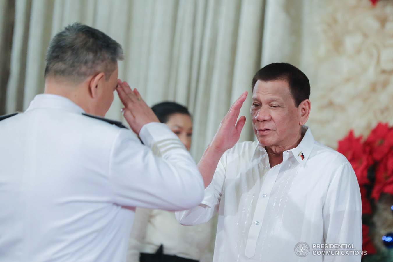 President Rodrigo Roa Duterte salutes one of the newly promoted uniformed personnel of the Philippine Coast Guard during the oath-taking ceremony at the Malacañan Palace on December 10, 2019. ALFRED FRIAS/PRESIDENTIAL PHOTO