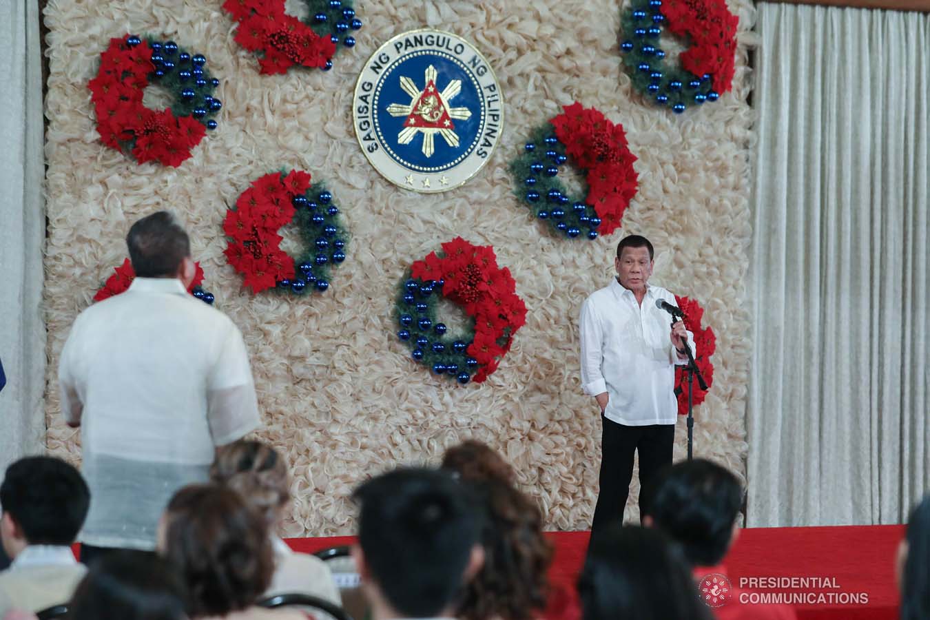 President Rodrigo Roa Duterte talks to Transportation Secretary Arthur Tugade while delivering his speech during the oath-taking ceremony of the newly promoted uniformed personnel of the Bureau of Fire Protection, Bureau of Jail Management and Penology and Philippine Coast Guard at the Malacañan Palace on December 10, 2019. ALFRED FRIAS/PRESIDENTIAL PHOTO