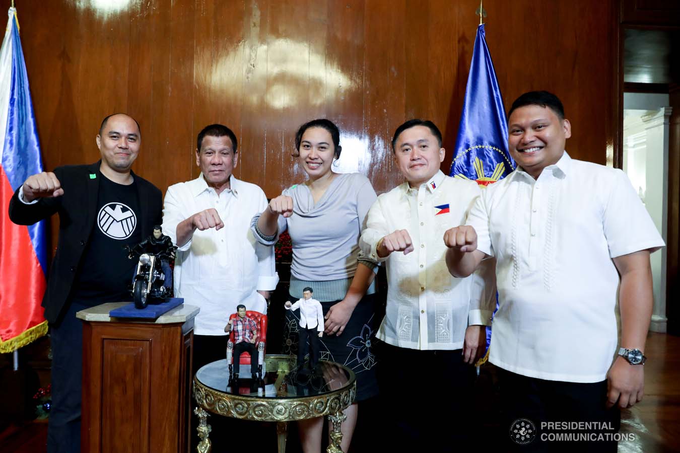 President Rodrigo Roa Duterte strikes his signature pose with toymaker Dennis Mendoza during their meeting at the at the Malacañan Palace on December 9, 2019. With the President is Senator Christopher "Bong" Go. ROBINSON NIÑAL JR./PRESIDENTIAL PHOTO