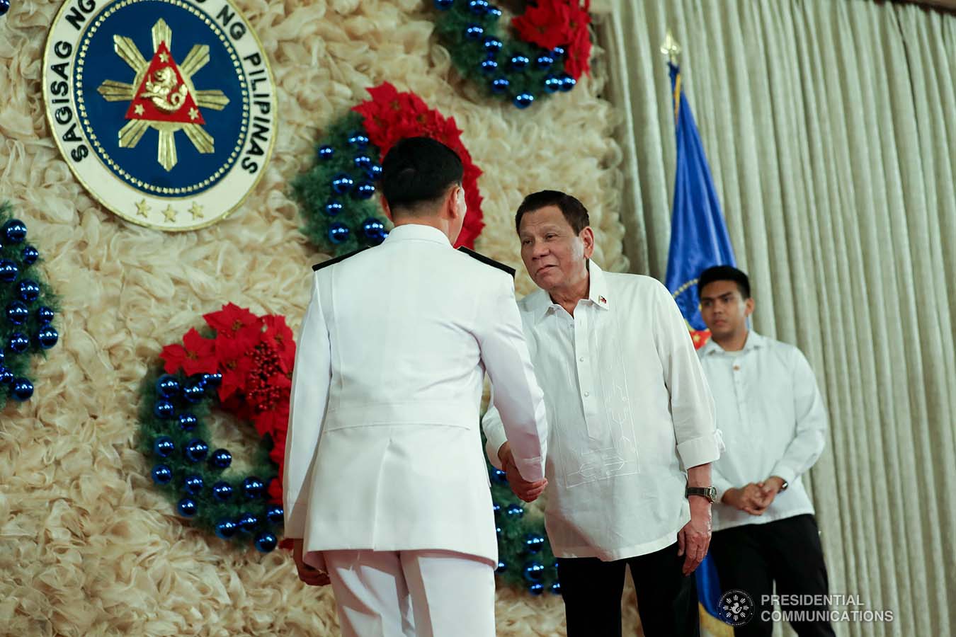 President Rodrigo Roa Duterte congratulates one of the newly-appointed flag officers of the Armed Forces of the Philippines during the oath-taking ceremony at the Malacañan Palace on December 9, 2019. ROBINSON NIÑAL JR./PRESIDENTIAL PHOTO