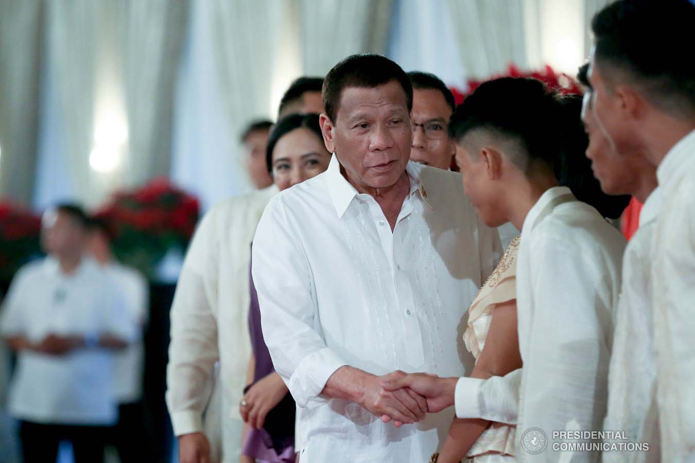 President Rodrigo Roa Duterte greets a family member of one of the newly promoted uniformed personnel of the Philippine Coast Guard during the oath-taking ceremony at the Malacañan Palace on December 10, 2019. SIMEON CELI JR./PRESIDENTIAL PHOTO