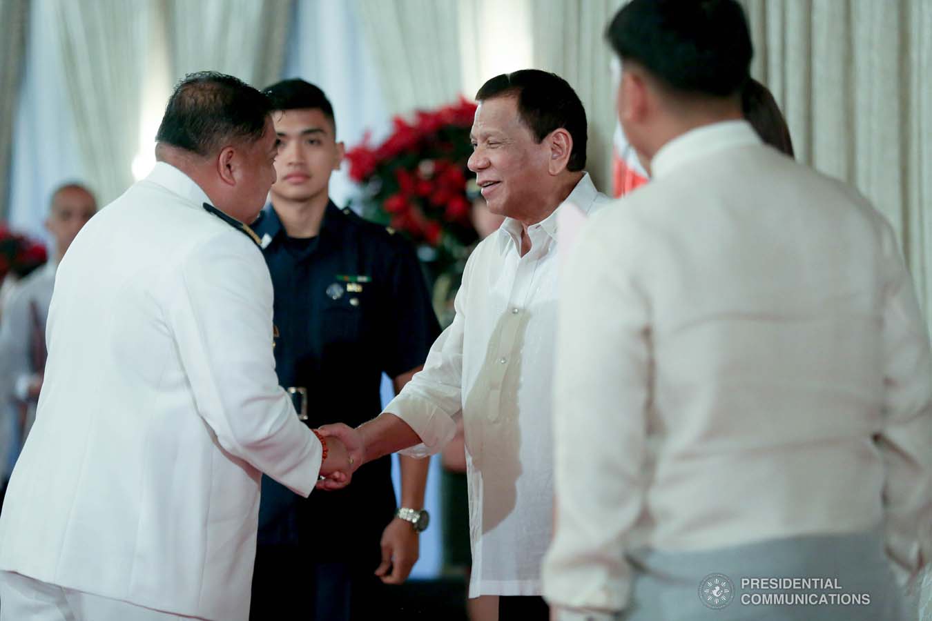 President Rodrigo Roa Duterte shares a light moment with one of the newly promoted uniformed personnel of the Philippine Coast Guard during the oath-taking ceremony at the Malacañan Palace on December 10, 2019. SIMEON CELI JR./PRESIDENTIAL PHOTO