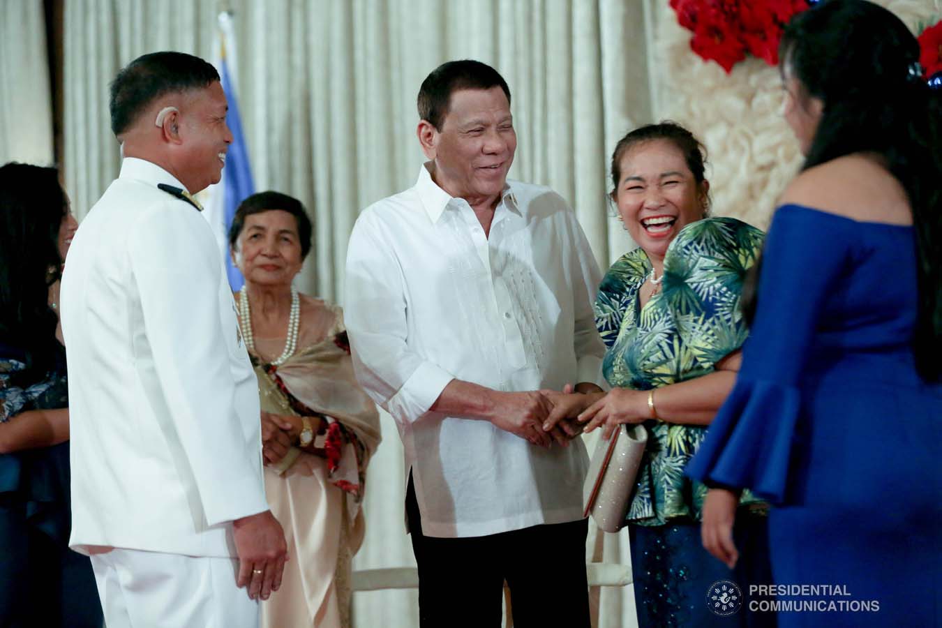 President Rodrigo Roa Duterte shares a light moment with the family members of newly promoted Commodore Edgar Buado during the oath-taking ceremony at the Malacañan Palace on December 10, 2019. SIMEON CELI JR./PRESIDENTIAL PHOTO