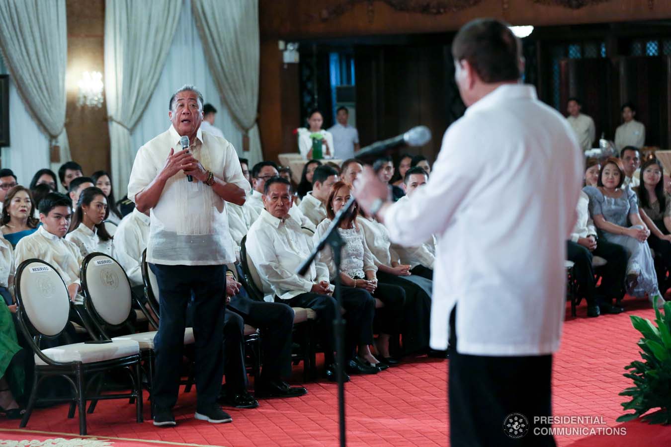 President Rodrigo Roa Duterte talks to Transportation Secretary Arthur Tugade while delivering his speech during the oath-taking ceremony of the newly promoted uniformed personnel of the Bureau of Fire Protection, Bureau of Jail Management and Penology and Philippine Coast Guard at the Malacañan Palace on December 10, 2019. SIMEON CELI JR./PRESIDENTIAL PHOTO