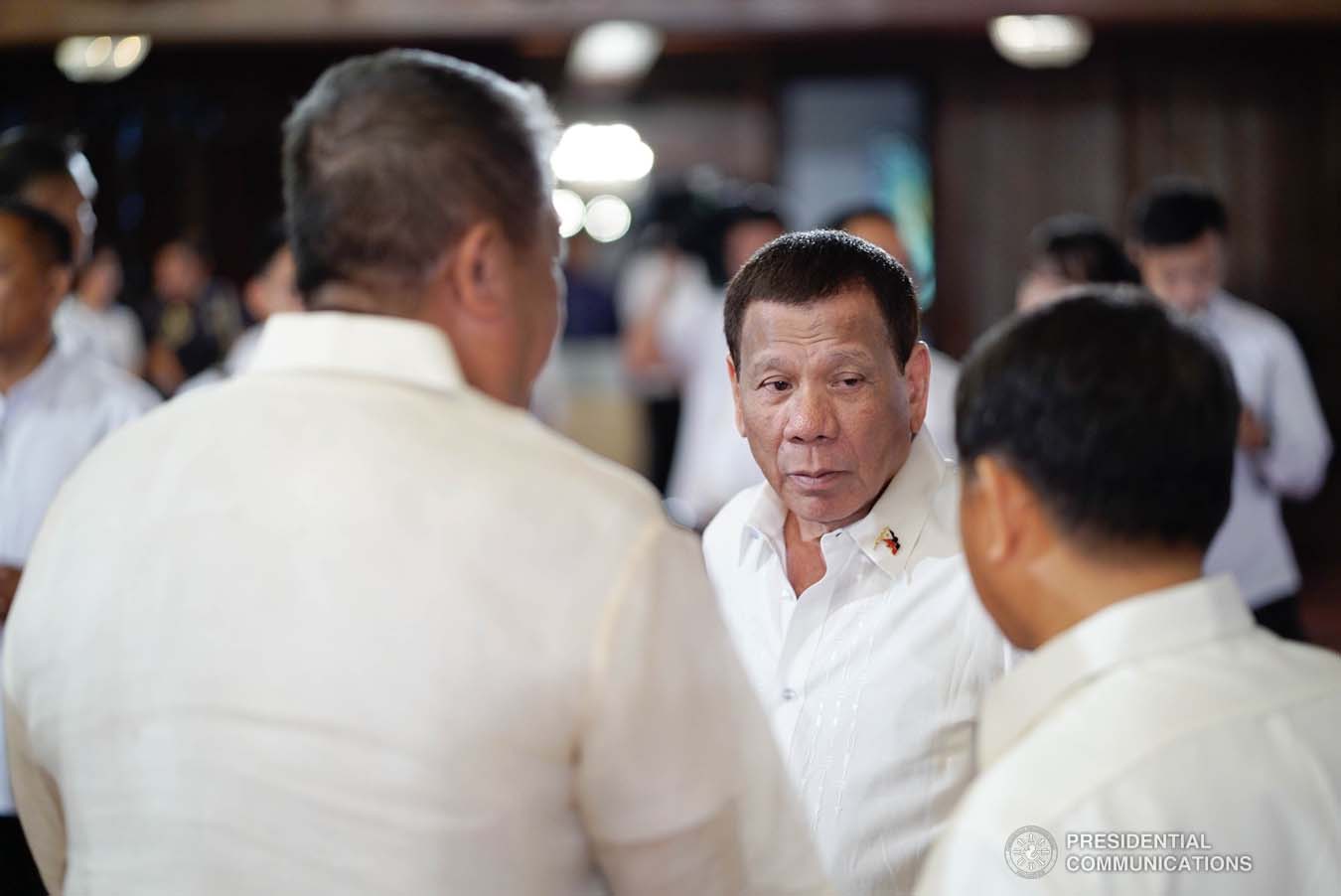 President Rodrigo Roa Duterte discusses matters with Transportation Secretary Arthur Tugade and Interior and Local Government Secretary Eduardo Año during the oath-taking ceremony of the newly promoted uniformed personnel of the Bureau of Fire Protection, Bureau of Jail Management and Penology and Philippine Coast Guard at the Malacañan Palace on December 10, 2019. KING RODRIGUEZ/PRESIDENTIAL PHOTO