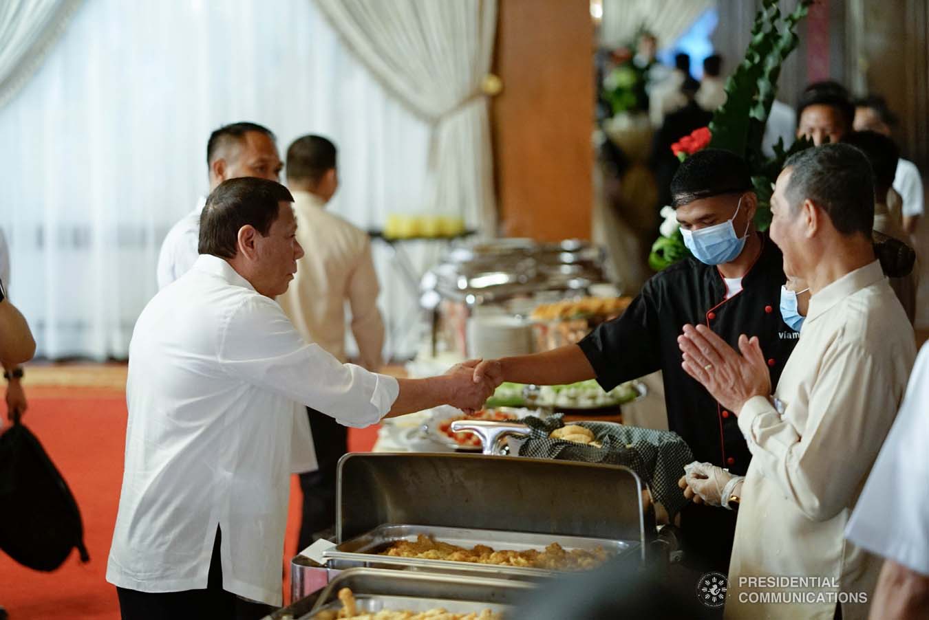 President Rodrigo Roa Duterte greets one of the kitchen staff on the sidelines of the oath-taking ceremony of the newly promoted uniformed personnel of the Bureau of Fire Protection, Bureau of Jail Management and Penology and Philippine Coast Guard at the Malacañan Palace on December 10, 2019. KING RODRIGUEZ/PRESIDENTIAL PHOTO