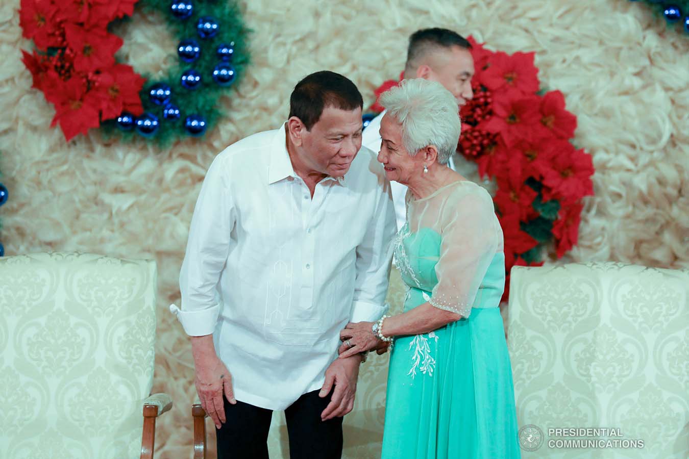 President Rodrigo Roa Duterte shares a light moment with Victoria Ancan, the mother of Major General Roberto Ancan, who was among the newly-appointed flag officers of the Armed Forces of the Philippines who took their oath before the President at the Malacañan Palace on December 9, 2019. KARL NORMAN ALONZO/PRESIDENTIAL PHOTO