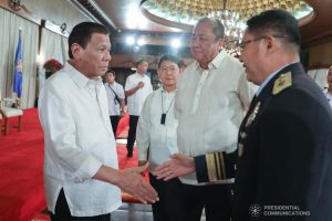 President Rodrigo Roa Duterte greets one of the newly promoted officers Bureau of Fire Protection during the oath-taking ceremony at the Malacañan Palace on December 10, 2019. Also in the photo are Transportation Secretary Arthur Tugade and Interior and Local Government Secretary Eduardo Año. RICHARD MADELO/PRESIDENTIAL PHOTO