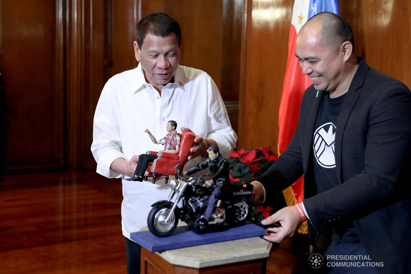 President Rodrigo Roa Duterte admires the miniature dolls given by toymaker Dennis Mendoza during their meeting at the Malacañan Palace on December 9, 2019. REY BANIQUET/PRESIDENTIAL PHOTO