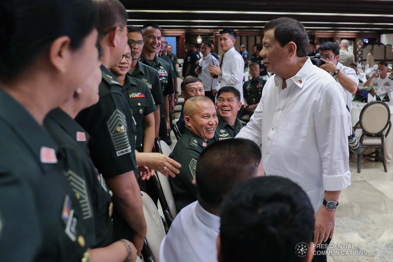 President Rodrigo Roa Duterte shares a light moment with some officers of the Armed Forces of the Philippines Council of the Sergeants Major during the Thanksgiving gathering he hosted at the Malacañan Palace on December 10, 2019. ALFRED FRIAS/PRESIDENTIAL PHOTO