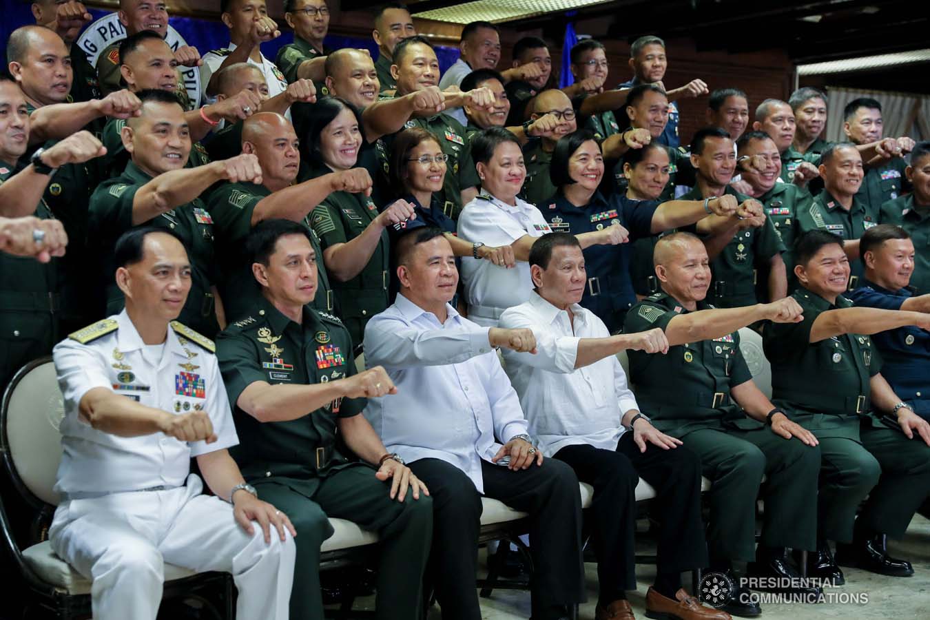 President Rodrigo Roa Duterte flashes his signature pose with the officers of the Armed Forces of the Philippines Council of the Sergeants Major during the Thanksgiving gathering he hosted at the Malacañan Palace on December 10, 2019. ALFRED FRIAS/PRESIDENTIAL PHOTO