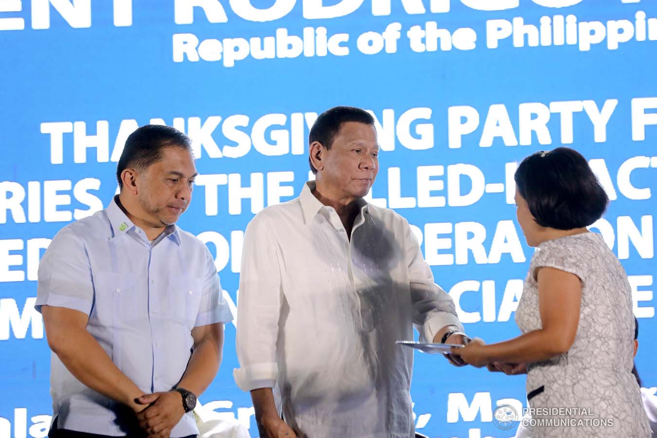 President Rodrigo Roa Duterte leads the ceremonial turnover of housing certificates and checks to the beneficiaries of the killed-in-action (KIA) soldiers and killed-in-police operation (KIPO) personnel under the Comprehensive Social Benefits Program during the Thanksgiving party at the Malacañan Palace on December 10, 2019. Assisting the President is National Housing Authority General Manager Marcelino Escalada Jr. ALFRED FRIAS/PRESIDENTIAL PHOTO