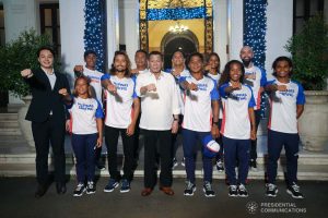 President Rodrigo Roa Duterte strikes his signature pose with the Philippine Surfing Team during a meeting at the Malacañan Palace on December 10, 2019. SIMEON CELI JR./PRESIDENTIAL PHOTO