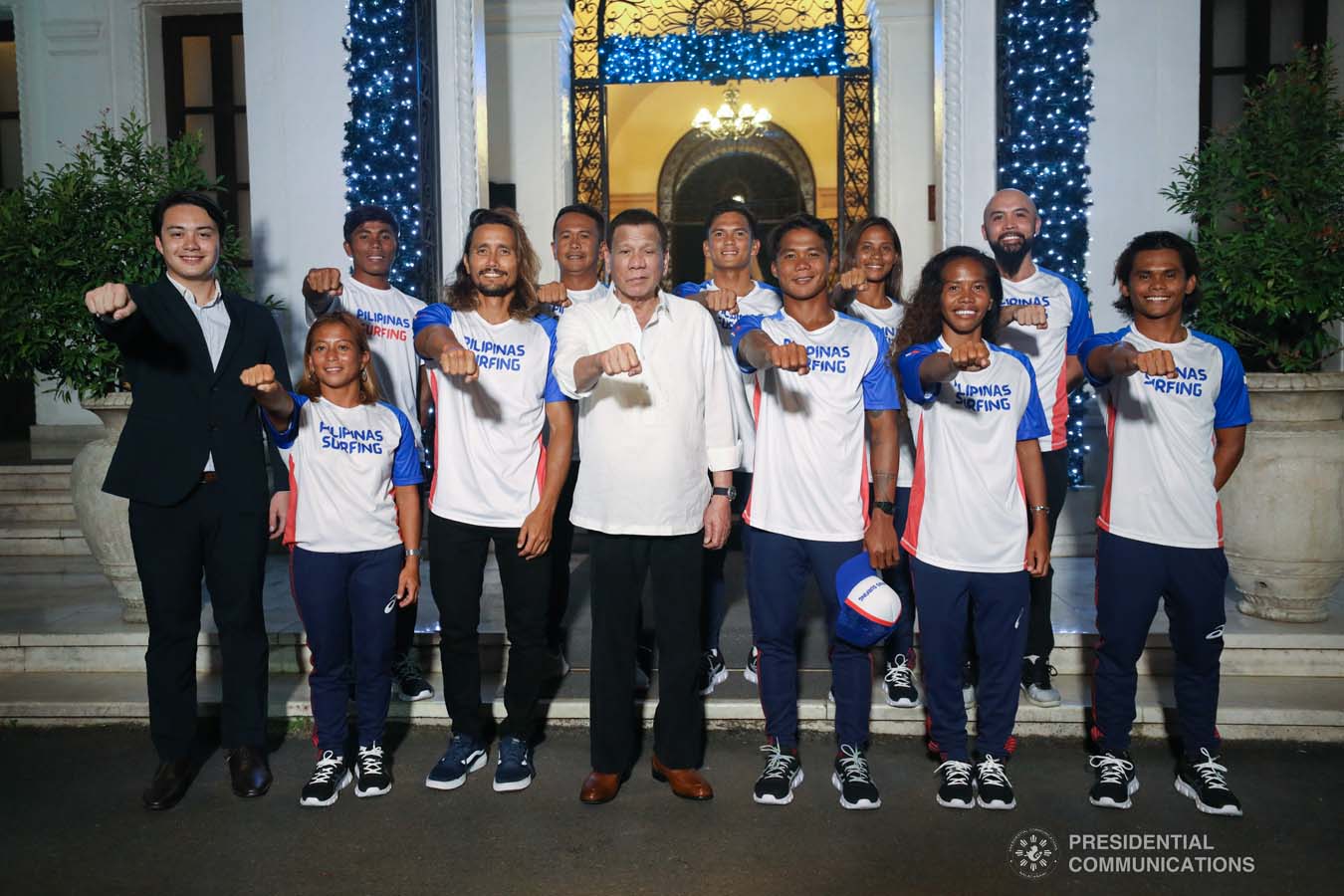 President Rodrigo Roa Duterte strikes his signature pose with the Philippine Surfing Team during a meeting at the Malacañan Palace on December 10, 2019. SIMEON CELI JR./PRESIDENTIAL PHOTO