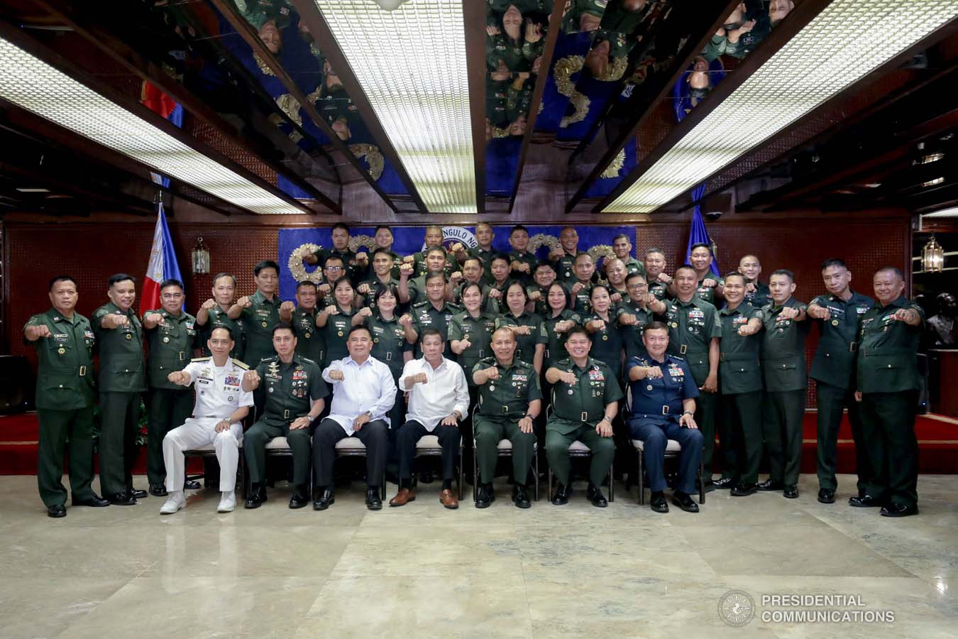 President Rodrigo Roa Duterte flashes his signature pose with officers of the Armed Forces of the Philippines Council of the Sergeants Major during the Thanksgiving gathering he hosted at the Malacañan Palace on December 10, 2019. SIMEON CELI JR./PRESIDENTIAL PHOTO