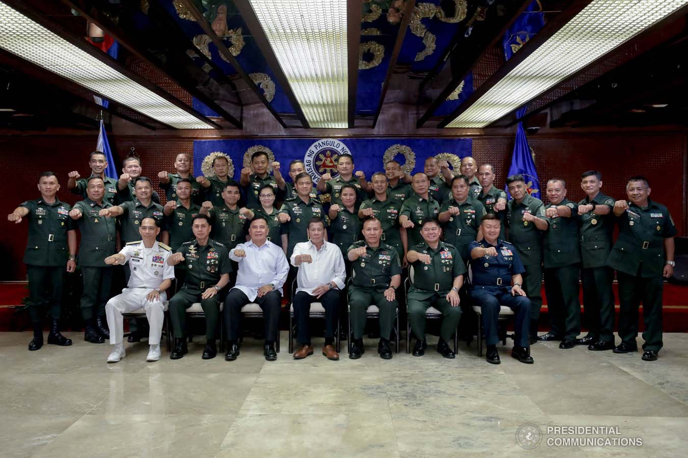 President Rodrigo Roa Duterte flashes his signature pose with officers of the Armed Forces of the Philippines Council of the Sergeants Major during the Thanksgiving gathering he hosted at the Malacañan Palace on December 10, 2019. SIMEON CELI JR./PRESIDENTIAL PHOTO